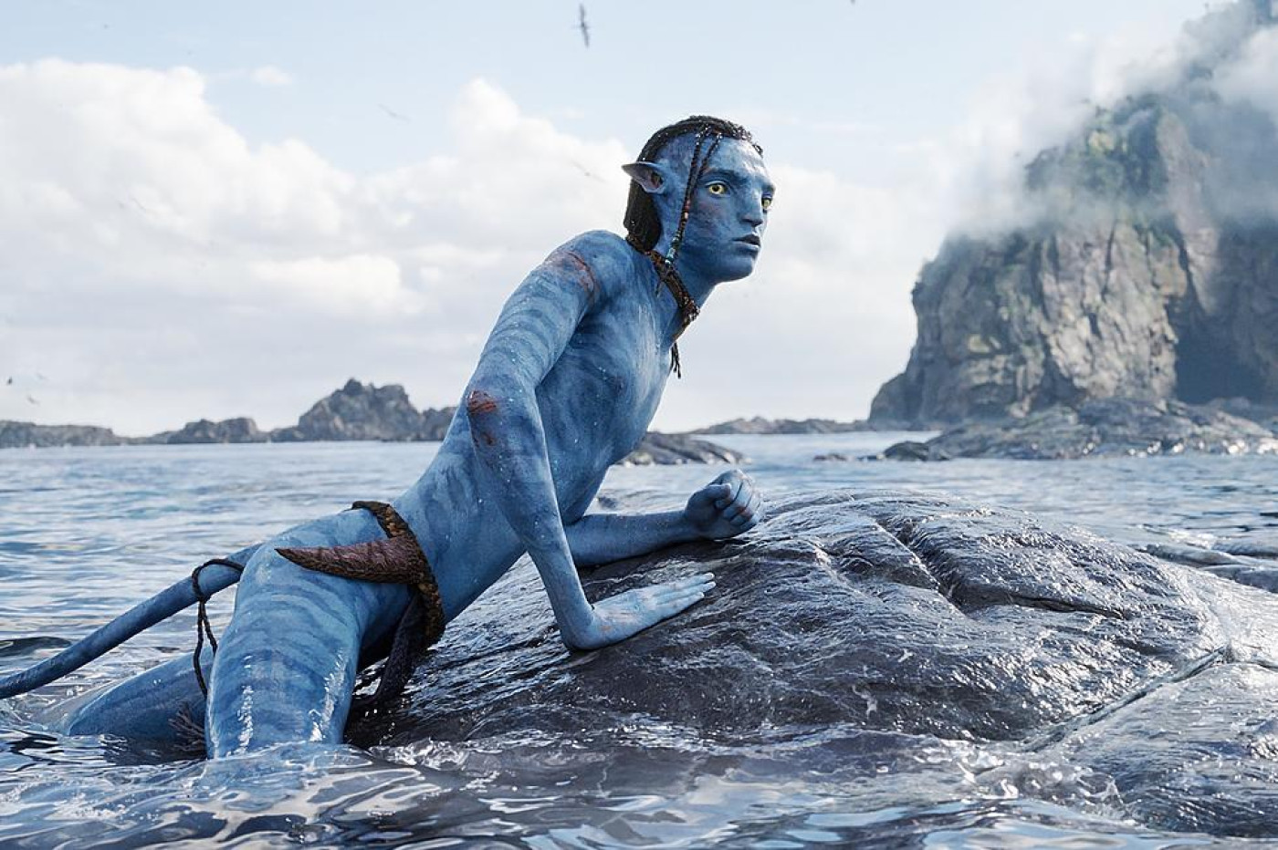 Lo'ak from Avatar 2 resting on a sea creature.