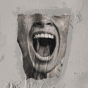 A blasted brick wall with a poster of a man screaming